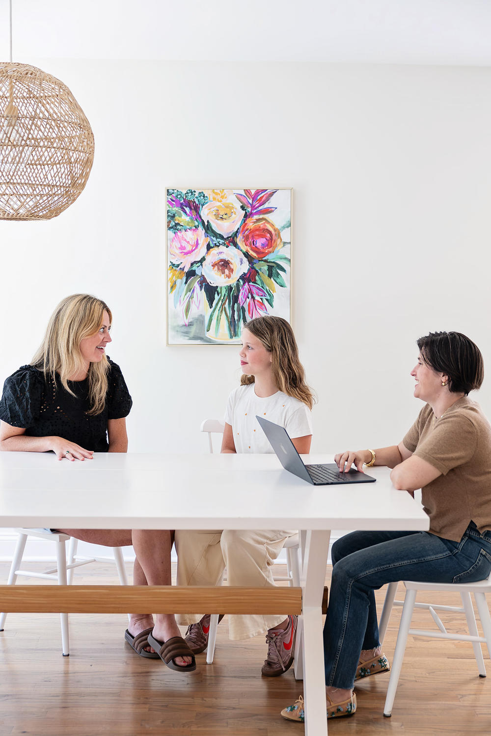 Katie talking with two students at a table